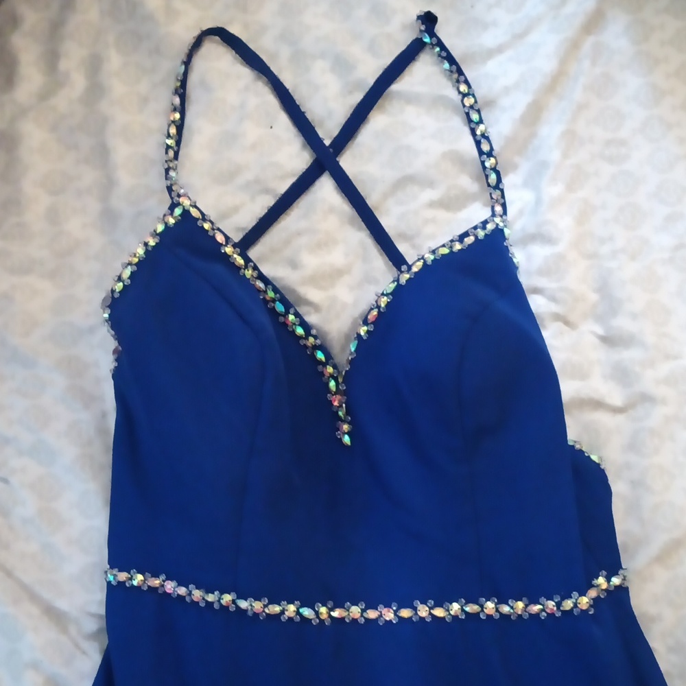 A size 13 B. Smart dress. It is a dark blue with gemstone details.